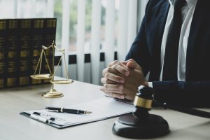 VIEW OF A NO WIN NO FEE PERSONAL INJURY LAWYER SEATED BEHIND A DESK