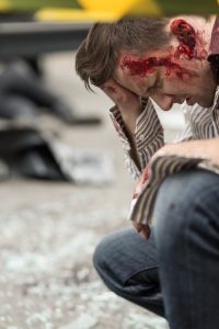 PERSON WITH MULTIPLE INJURIES INCLUDING BLEEDING HEAD INJURY AFTER A ROAD TRAFFIC ACCIDENT