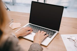 A woman prepares to use a sexual abuse compensation calculator on her laptop.