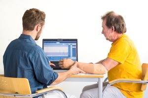 An arm amputee is discussing recovery with a medical professional 