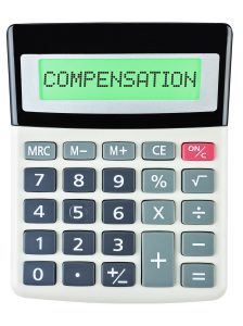 A calculator shows the word 'compensation' on its display. 