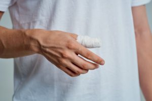 Man with bandaged thumb. 