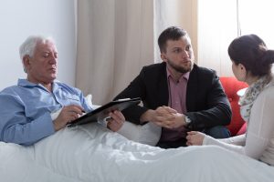 A solicitor explaining to an injured man how to use a public liability claim compensation calculator.