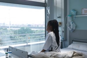 Woman looking out of hospital window.