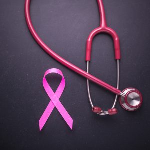 PINK RIBBON AND STETHOSCOPE TO INDICATE BREAST CANCER AWARENESS